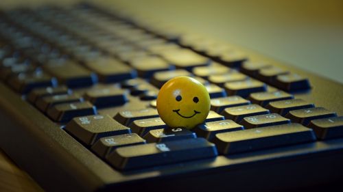 Smiley standing on a keyboard HD Wallpaper