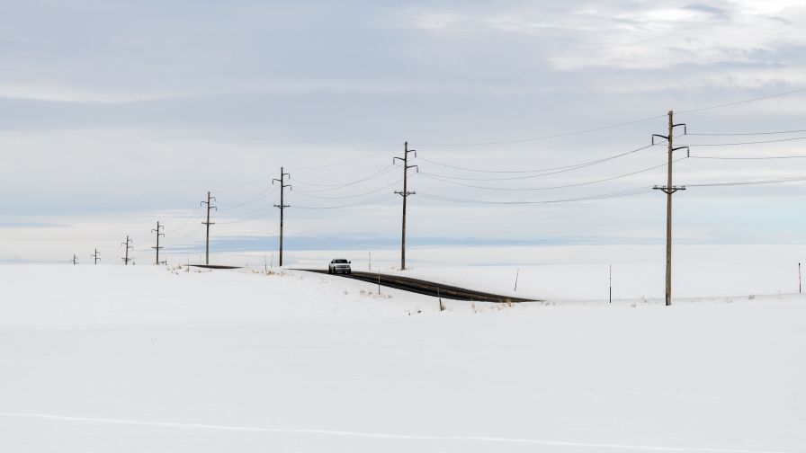 Car on a snowy road HD Wallpaper