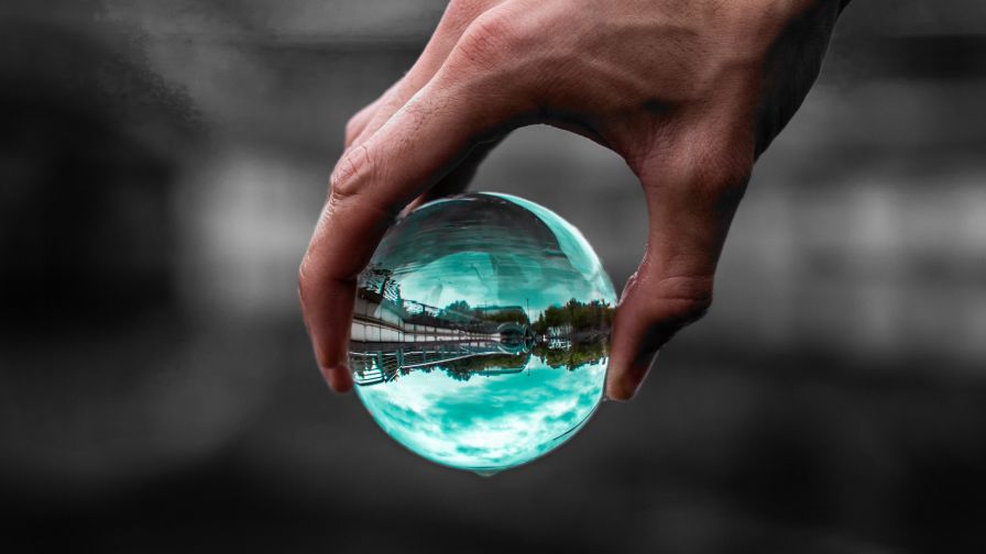 Glass ball on hand HD Wallpaper