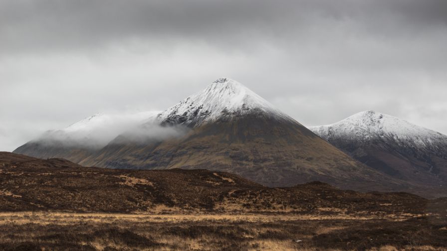 Grey clouds over snowy mountains HD Wallpaper