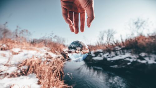 Hand trying to reach a transparent ball HD Wallpaper