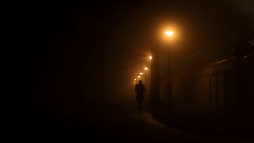Man walking under street lanterns HD Wallpaper