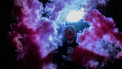 Man wearing a mask through colored smoke HD Wallpaper