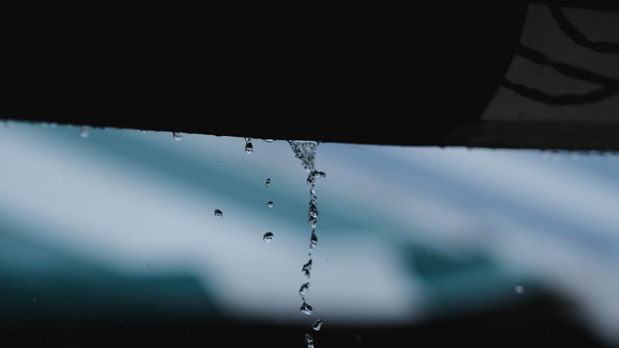 Rain drops falling of he roof HD Wallpaper