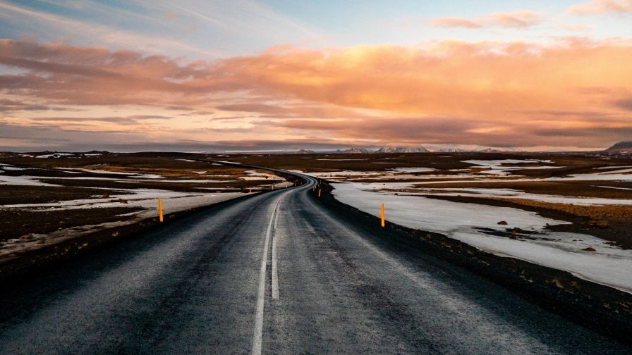 Sunset over a road covered in snow HD Wallpaper